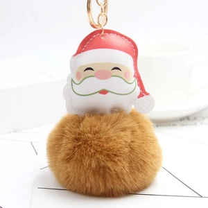 Detailed view of Santa Claus plush keychain with fluffy brown faux fur ball and gold ring