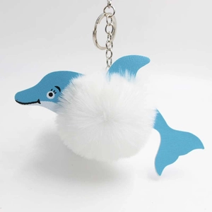 Blue leather dolphin keychain with a soft white fluffy pompom and silver metal ring