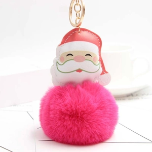 Detail of Santa Claus plush keychain with pink fur ball and golden metal ring clip