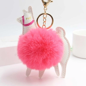 Detail of white PU leather alpaca keychain with large pink pom-pom and gold metal clasp