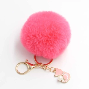 Detailed view of rose red pompom keychain with golden metal clasp and pink enamel cat