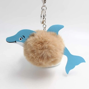 Detail of blue faux leather dolphin plush ball keychain with silver lobster clasp and ring
