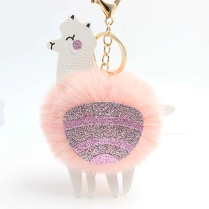 Pink alpaca faux fur keychain with white faux leather details and gold glitter accents