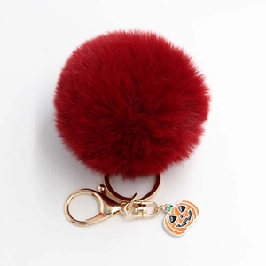 Porte-clés pompon rouge foncé avec anneau doré et pendentif citrouille pour Halloween