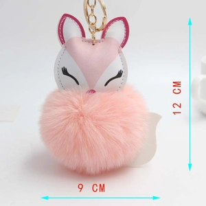 Detail showing pink fox plush keychain with leather face and size dimensions of 12cm by 9cm
