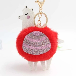 Detail of alpaca plush keychain with red faux fur, pink sequins and golden hardware
