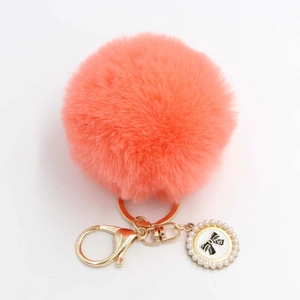 Orange faux fur pompom keychain with golden lobster clasp and pearl bow charm