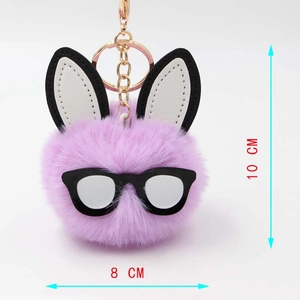 Detail view of purple plush bunny pompom keychain with size dimensions 10cm by 8cm