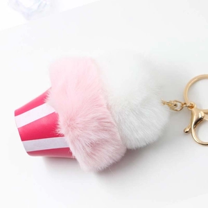 Pink and white plush ice cream cupcake keychain with red striped base and gold clasp