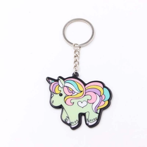 Détail d'un porte-clés licorne en PVC vert souple avec des cheveux colorés et anneau argent