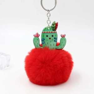Detail of green acrylic cactus pendant with fluffy red faux fur pom-pom keychain