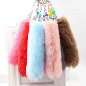 Close-up of colorful faux fox fur tail keychains showing various fluffy textures and colors