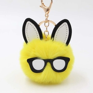 Cute yellow plush bunny keychain with stylish black glasses and gold metal clasp
