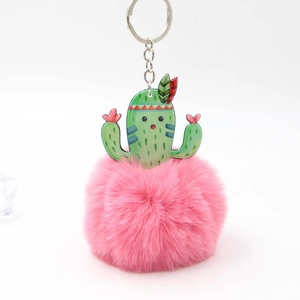 Detail view of pink faux fur pompom and acrylic cactus charm with silver metal keyring