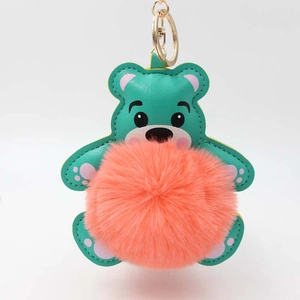 Detailansicht von petrolfarbenem Leder-Teddybär-Anhänger mit orangefarbenem Bommel