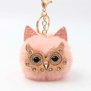 Detail of pink owl plush keychain with glitter sequins and gold metallic ring