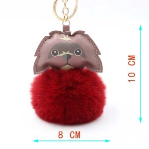 Detailed view of brown dog head plush pom pom keychain with gold ring and size dimensions