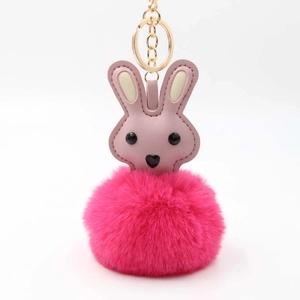 Cute pink bunny plush pompom keychain with faux leather details and gold-tone metal ring