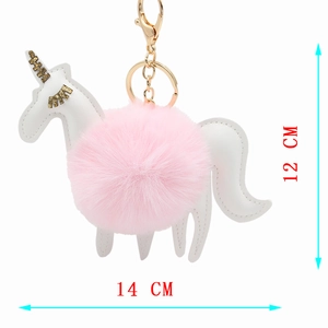 Detail showing plush unicorn keychain dimensions of 14cm width and 12cm height