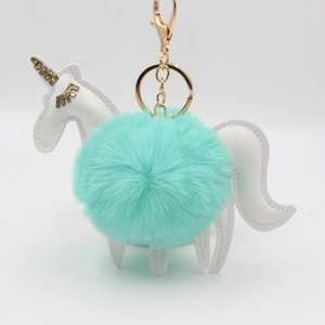Unicorn plush keychain with turquoise faux fur ball and gold glitter accents