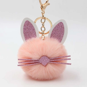 Pink plush rabbit fur ball keychain with glitter ears and gold clip for handbag