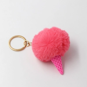 Detail of pink faux fur pompom ice cream keychain with textured plastic cone and gold ring