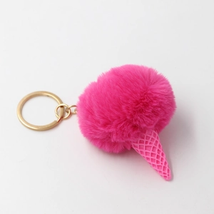 Pink faux fur pompom ice cream keychain with resin cone on white background