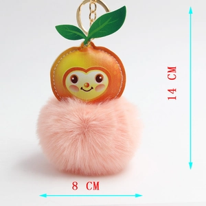 Detailed size view of cute plush peach keychain with pink pompom and golden carabiner