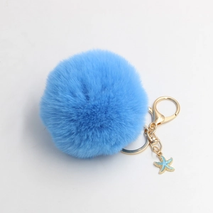 Starfish faux fur pom pom keychain with gold ring and blue starfish charm accessory