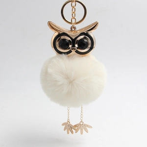 Charming owl keychain with white faux rabbit fur pompom and gold alloy details