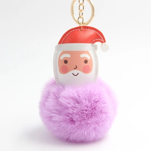 Detail of Santa Claus keychain with purple faux fur pompom and golden metal ring