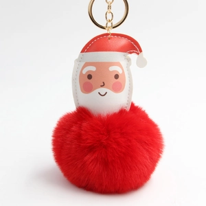 Detail of Santa Claus plush keychain with large red faux fur pompom and golden ring