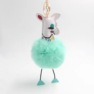 Détail du porte-clés girafe avec pompon en fausse fourrure vert menthe et crochet doré