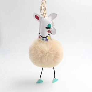 Détail macro du porte-clés alpaga en peluche avec boule de poils et anneau doré