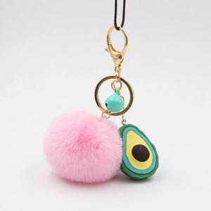 Pink fluffy faux fur pompom keychain with cute avocado charm and green bell accessory