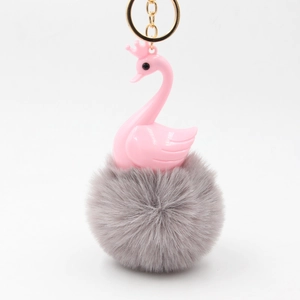 Pink swan keychain with grey faux fur pom-pom and golden metal ring for bags