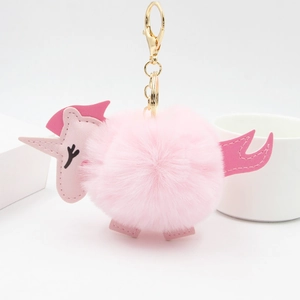 Pink plush unicorn fur ball keychain with golden metal ring and soft faux fur for bag charms
