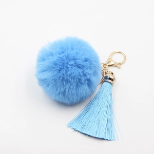 Porte-clés pompon en fausse fourrure bleu ciel avec longue frange et fermoir doré