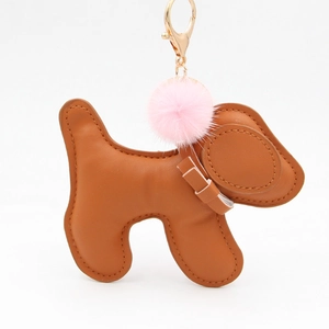 Cute puppy bag charm in brown leather with pink faux fur pompom and gold keychain hook