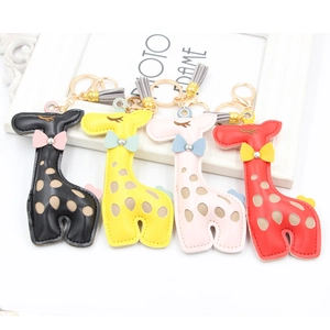 Detailed view of colorful PU leather giraffe keychains with tassels and bowknot charms