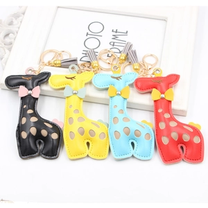 Detail view of colorful PU leather giraffe keychains with stylish tassels and gold hardware