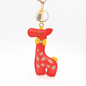 Detail of red giraffe PU leather keychain featuring golden hardware and a small tassel