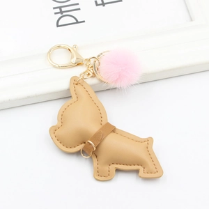 Detail of camel PU leather bulldog keychain with pink faux fur pompom and gold clasp