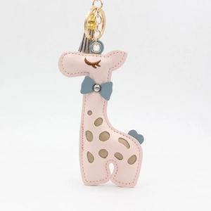 Detail of pink leather giraffe keychain with tassel and gold metal spring clasp