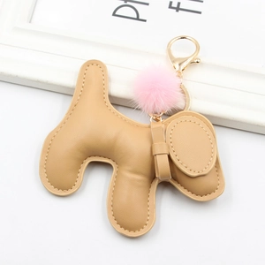 Detail of cute leather dog keychain with pink faux fur pom and golden lobster clasp