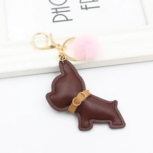 Cartoon dark brown leather dog keychain with pink fur pompom and gold hardware