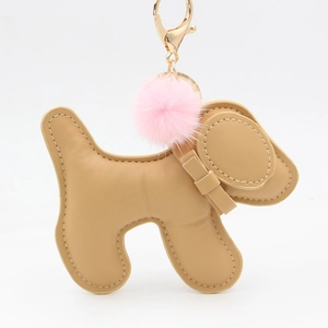 Detail of cute puppy bag charm featuring brown leather and pink fluffy fur pompom
