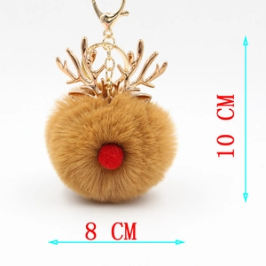 Detailed view of plush reindeer keychain with 10cm x 8cm dimensions and gold metal antlers
