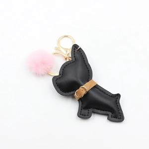Detail of black leather French Bulldog keychain with pink faux fur pom and golden metal clip