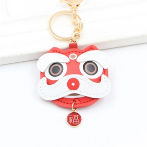 Detail of red PU leather Chinese lion keychain with gold lucky charm and spring clasp